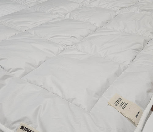 UNWONTED alpaca duvet in production workshop showing baffle-box construction
